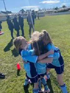 hugging junior soccer players in blue